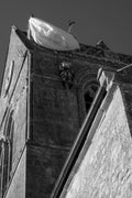 A parachute canopy and paratrooper effigy hanging from the church steeple at Sainte-Mère-Église, Normandy