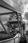 The steel bascule and counterweight of Pegasus Bridge seen from underneath against cloud, Bénouville, Normandy