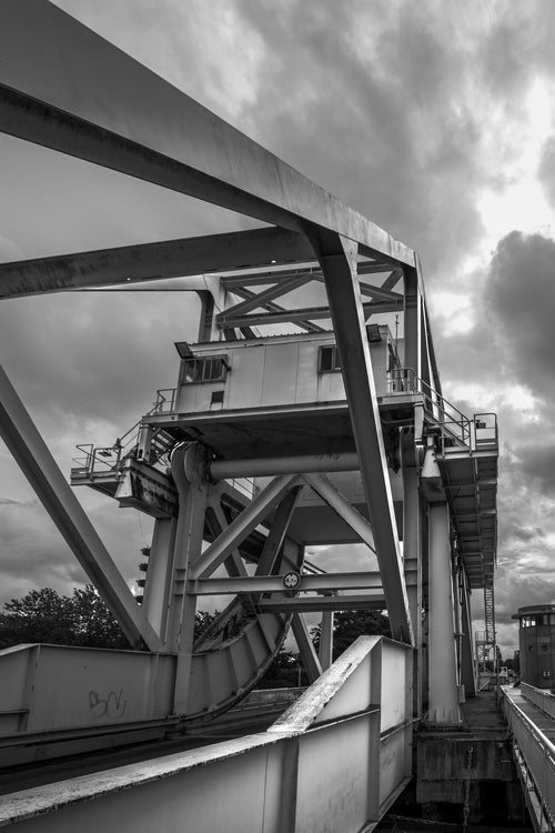 The steel bascule and counterweight of Pegasus Bridge seen from underneath against cloud, Bénouville, Normandy