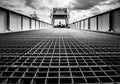 The metal grating of the Pegasus Bridge deck running away in perspective towards the raised bascule, Bénouville