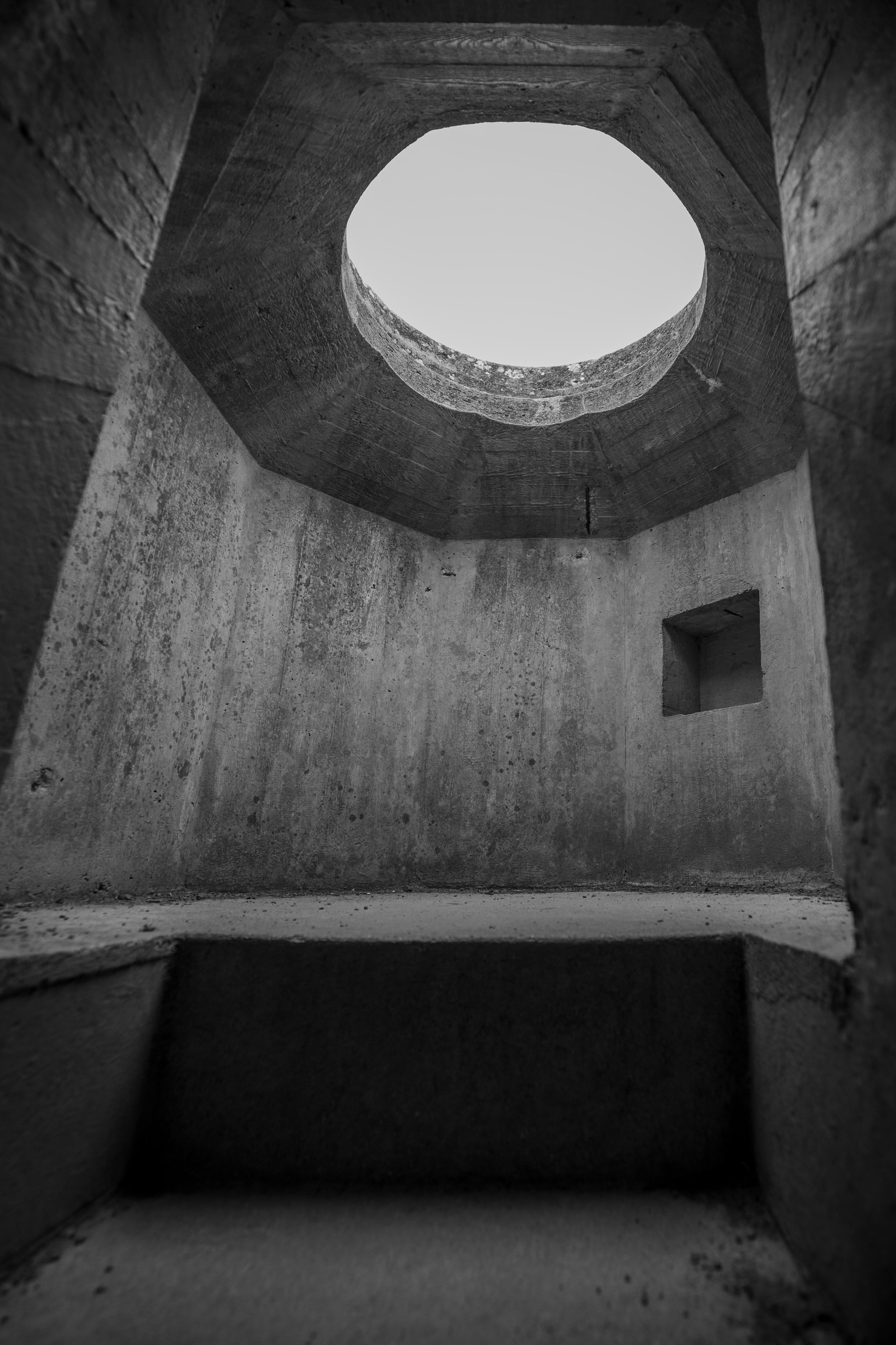 Inside the concrete observation post at the Merville Battery, looking up at the circular opening cut for the periscope