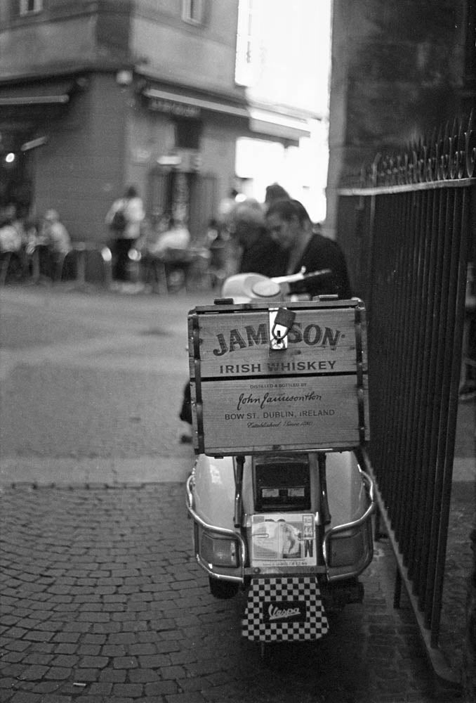 A parked Vespa outside a whiskey bar in the Quartier Bouffay, Nantes, black and white